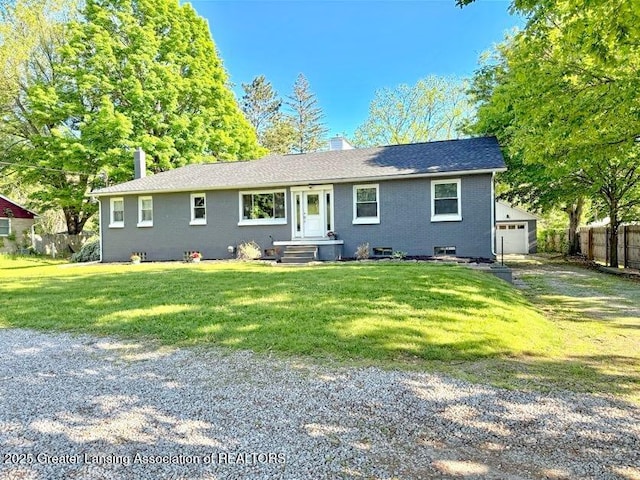 2215 Haslett Rd, East Lansing, MI 48823 - ranch-style home with a chimney, a detached garage, and brick siding