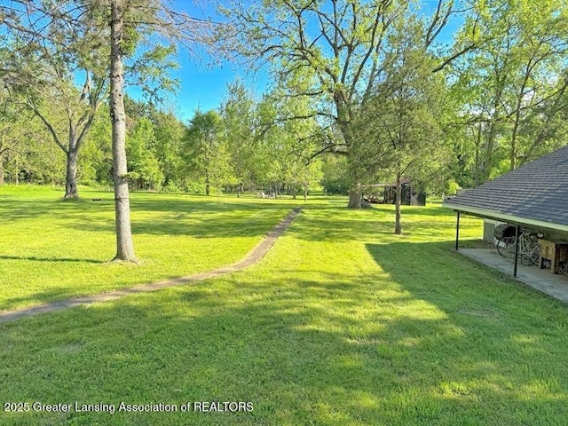 2215 Haslett Rd, East Lansing, MI 48823 - view of home's community featuring a yard and view of scattered trees