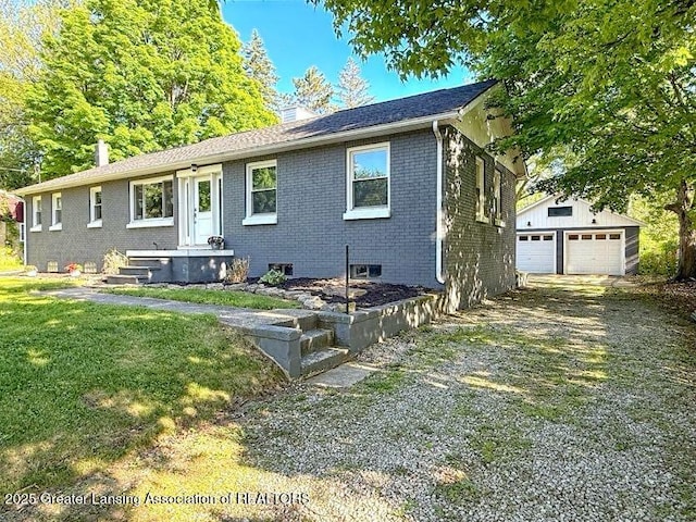2215 Haslett Rd, East Lansing, MI 48823 - view of front of property featuring brick siding, an outdoor structure, a garage, a chimney, and driveway