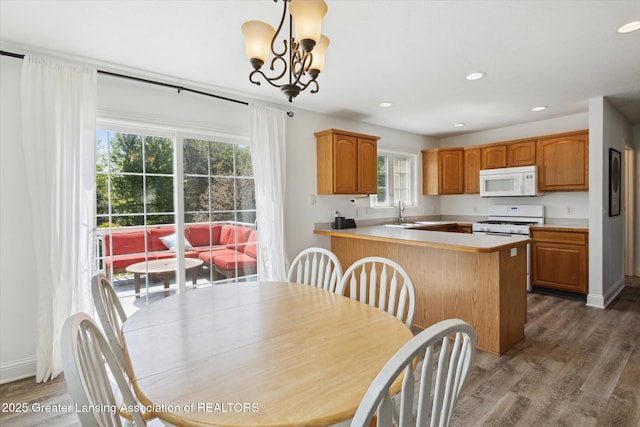3795 Kirkland Ridge Dr, Holt, MI 48842 - dining area featuring plenty of natural light, wood finished floors, recessed lighting, and a chandelier