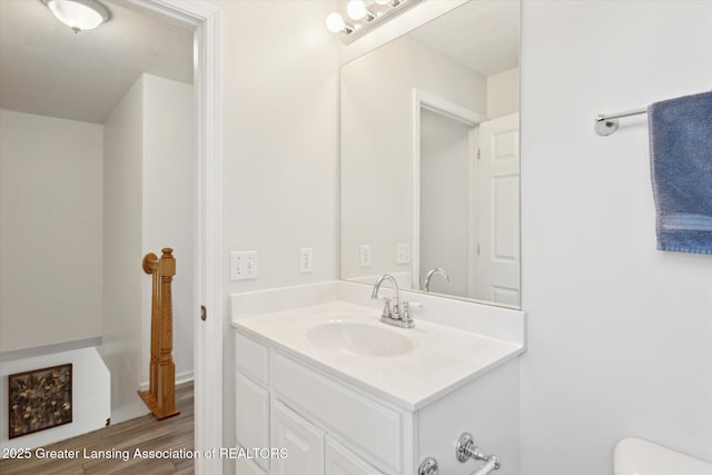3795 Kirkland Ridge Dr, Holt, MI 48842 - half bath featuring toilet, vanity, and wood finished floors