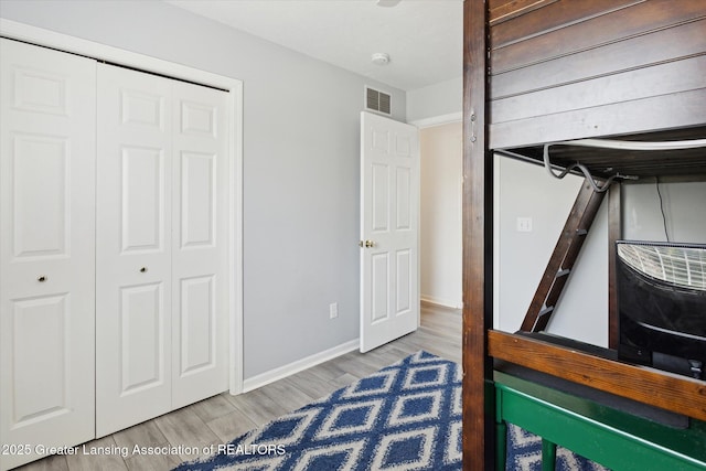 3795 Kirkland Ridge Dr, Holt, MI 48842 - unfurnished bedroom with wood finished floors, a closet, and baseboards