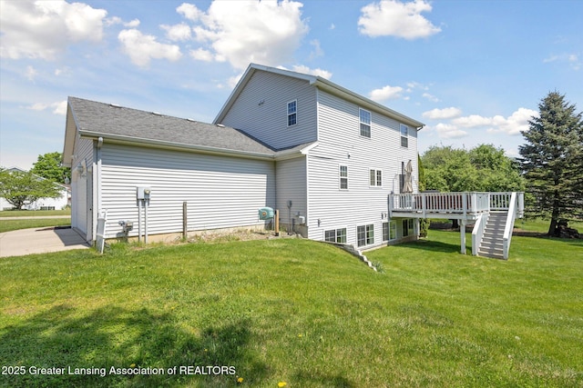3795 Kirkland Ridge Dr, Holt, MI 48842 - rear view of property with stairs, a wooden deck, a yard, an attached garage, and concrete driveway