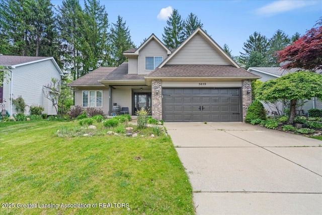 5859 Printemp Dr, East Lansing, MI 48823 - traditional home featuring an attached garage, a front yard, driveway, brick siding, and roof with shingles