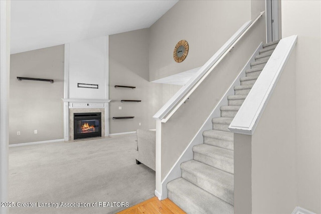 5859 Printemp Dr, East Lansing, MI 48823 - staircase featuring a tile fireplace, baseboards, and wood finished floors