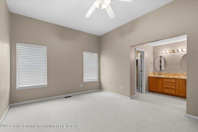 5859 Printemp Dr, East Lansing, MI 48823 - unfurnished bedroom featuring light carpet, baseboards, a sink, and ensuite bathroom
