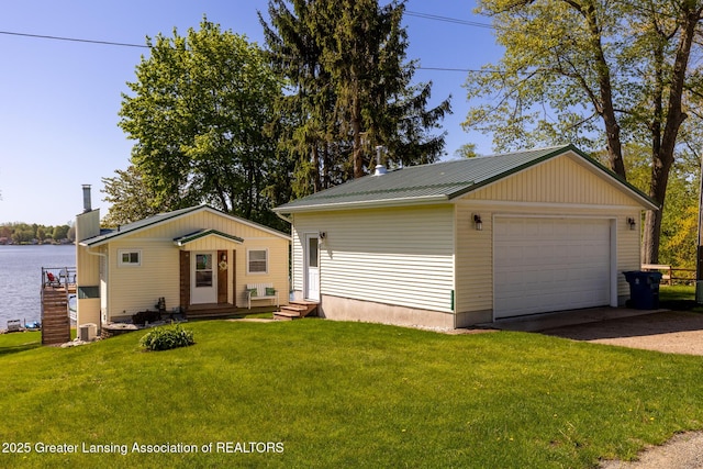 6391 Lakeshore Dr, Lakeview, MI 48850 - view of front of home featuring a garage, a front lawn, metal roof, and an outdoor structure