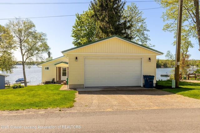 6391 Lakeshore Dr, Lakeview, MI 48850 - view of front of house with a front lawn, a water view, entry steps, and a garage