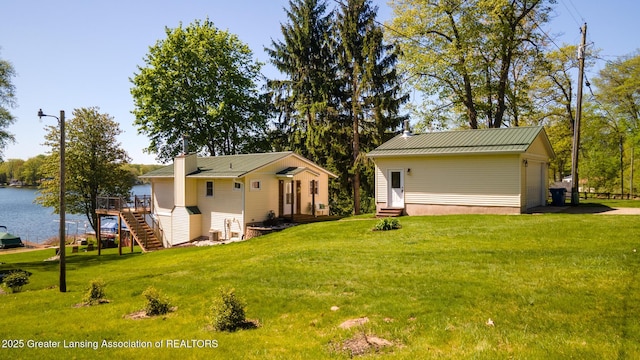 6391 Lakeshore Dr, Lakeview, MI 48850 - rear view of property with entry steps, a yard, stairs, a deck with water view, and metal roof