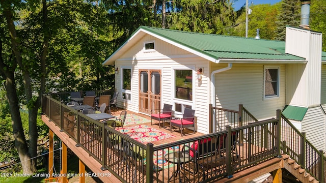 6391 Lakeshore Dr, Lakeview, MI 48850 - rear view of property featuring stairway, metal roof, and a wooden deck