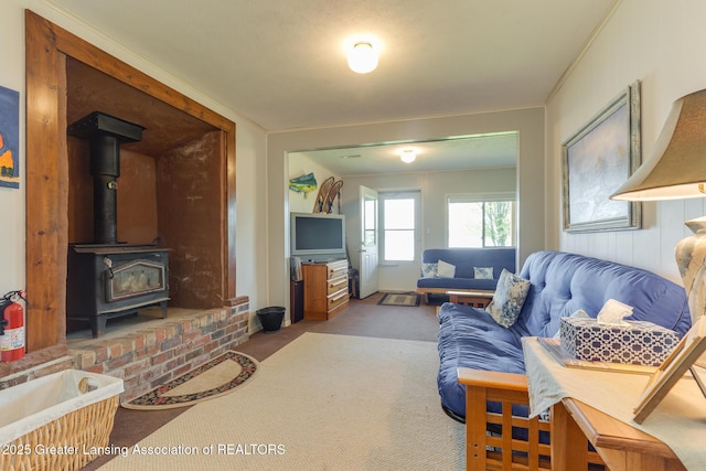 6391 Lakeshore Dr, Lakeview, MI 48850 - carpeted living area featuring a wood stove and crown molding