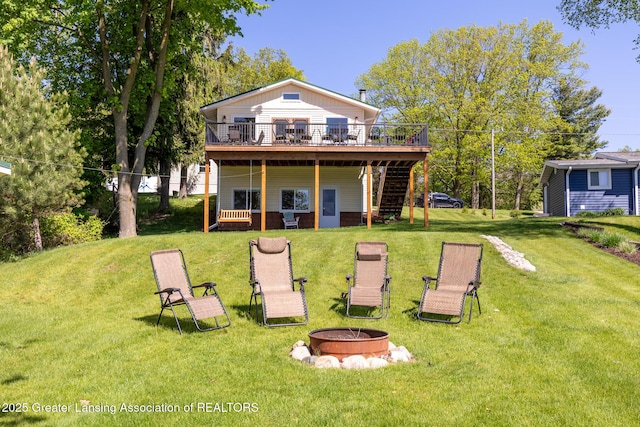 6391 Lakeshore Dr, Lakeview, MI 48850 - rear view of house with a fire pit, stairway, a deck, and a yard