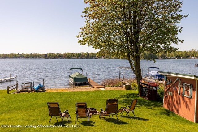 6391 Lakeshore Dr, Lakeview, MI 48850 - view of green lawn featuring a water view and a dock