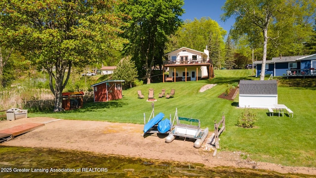6391 Lakeshore Dr, Lakeview, MI 48850 - view of grassy yard featuring a shed, an outbuilding, and a wooden deck
