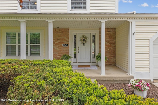 1347 N Creyts Rd, Lansing, MI 48917 - entrance to property with a porch and brick siding