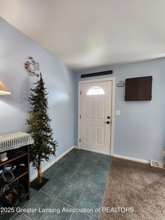 136 N Chestnut St, Owosso, MI 48867 - foyer entrance featuring baseboards