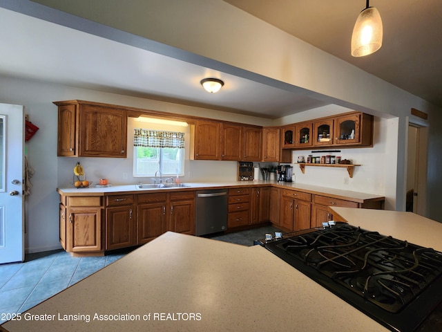 136 N Chestnut St, Owosso, MI 48867 - kitchen with dishwasher, a sink, light countertops, brown cabinetry, and black range with gas stovetop