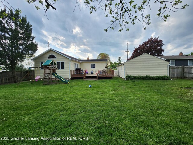 136 N Chestnut St, Owosso, MI 48867 - view of yard with a playground and a wooden deck