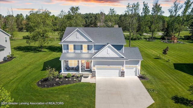 4150 Stillbrook Ln, Dewitt, MI 48820 - view of front of property with concrete driveway, covered porch, a garage, a lawn, and stone siding