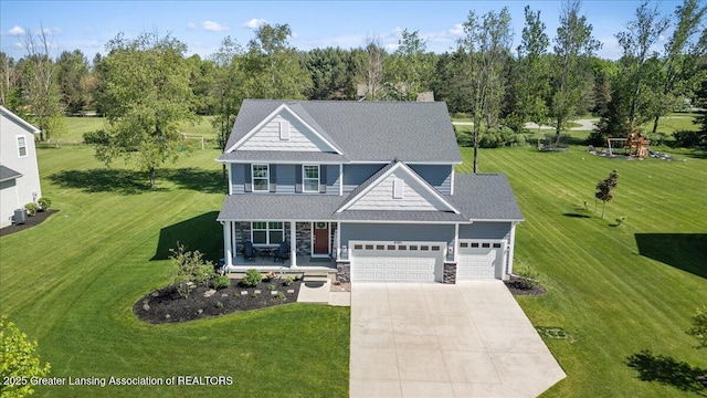 4150 Stillbrook Ln, Dewitt, MI 48820 - view of front of property with covered porch, driveway, a garage, a front lawn, and stone siding