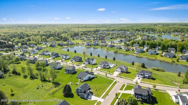 4150 Stillbrook Ln, Dewitt, MI 48820 - aerial perspective of suburban area featuring a large body of water and a heavily wooded area