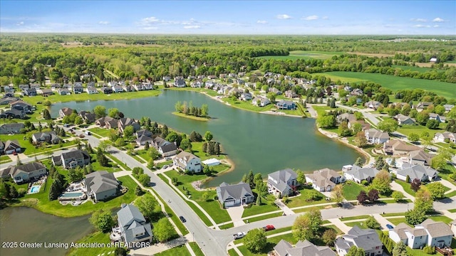 4150 Stillbrook Ln, Dewitt, MI 48820 - aerial view of residential area featuring a nearby body of water and a heavily wooded area
