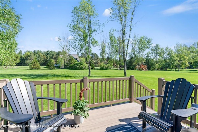 4150 Stillbrook Ln, Dewitt, MI 48820 - wooden deck featuring a playground, a yard, and view of wooded area