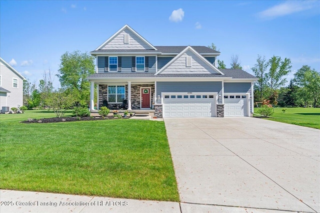4150 Stillbrook Ln, Dewitt, MI 48820 - craftsman-style home with a garage, stone siding, driveway, a front yard, and covered porch