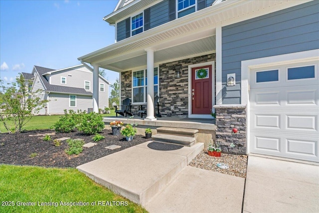 4150 Stillbrook Ln, Dewitt, MI 48820 - doorway to property with a porch, stone siding, and a garage