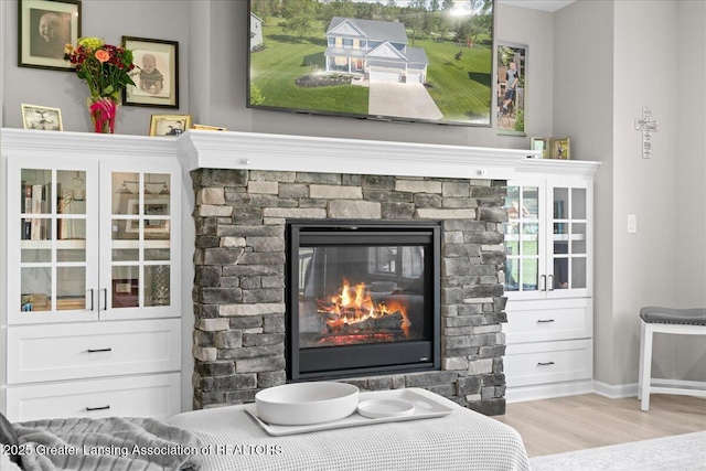 4150 Stillbrook Ln, Dewitt, MI 48820 - detailed view of wood finished floors, a fireplace, and baseboards