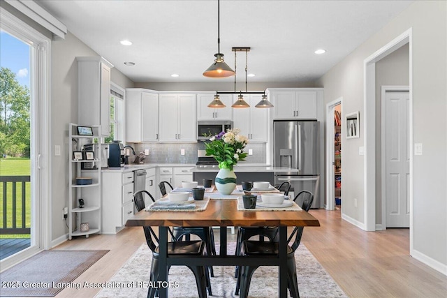 4150 Stillbrook Ln, Dewitt, MI 48820 - dining space with light wood-style floors, recessed lighting, and baseboards