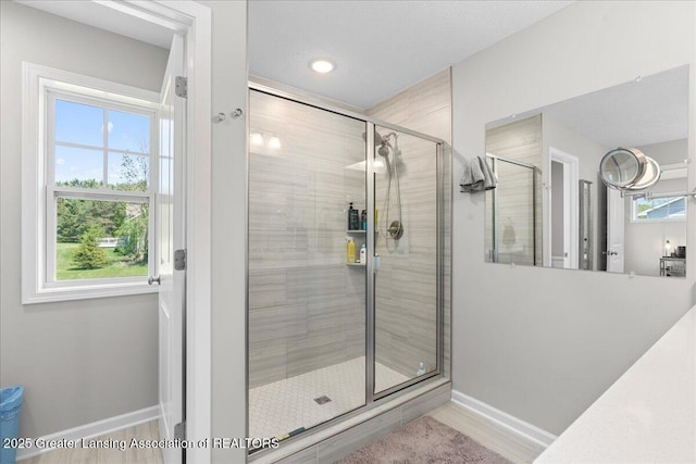 4150 Stillbrook Ln, Dewitt, MI 48820 - bathroom featuring baseboards, a stall shower, and recessed lighting