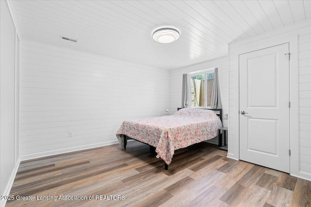 4150 Stillbrook Ln, Dewitt, MI 48820 - bedroom with wood finished floors, wood ceiling, and baseboards