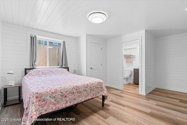 4150 Stillbrook Ln, Dewitt, MI 48820 - bedroom featuring light wood-style flooring, wooden walls, ensuite bathroom, wood ceiling, and baseboards