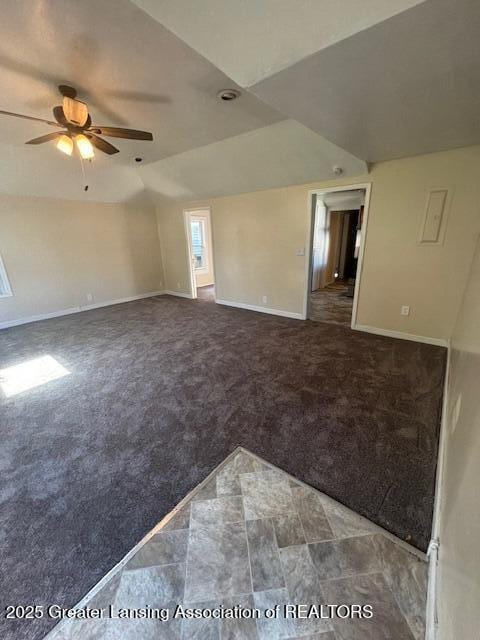107 Cox Blvd, Lansing, MI 48910 - carpeted spare room featuring lofted ceiling, a ceiling fan, and baseboards