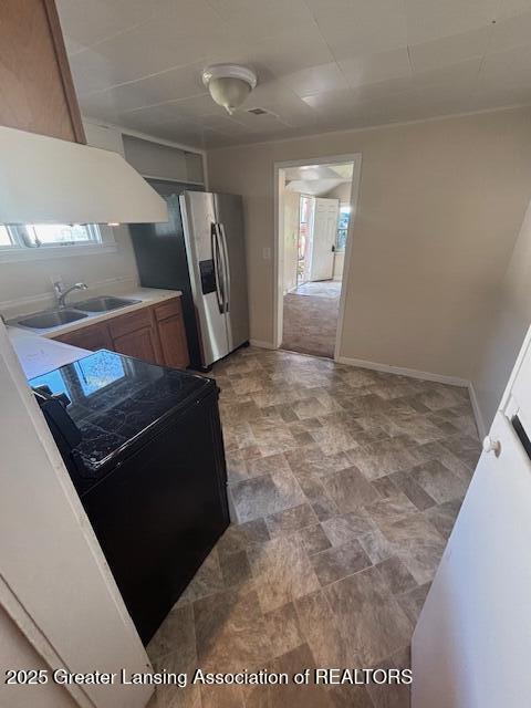107 Cox Blvd, Lansing, MI 48910 - kitchen with a sink, range, plenty of natural light, and stainless steel fridge