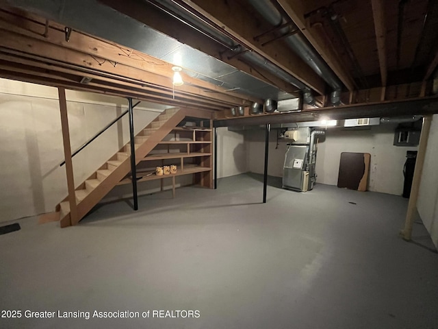 7436 Creekside Dr Unit 10, Lansing, MI 48917 - below grade area featuring stairs and heating unit