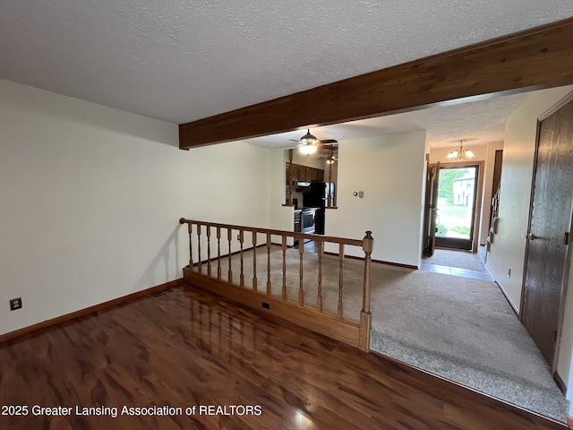 7436 Creekside Dr Unit 10, Lansing, MI 48917 - staircase featuring a textured ceiling, baseboards, wood finished floors, a chandelier, and beam ceiling