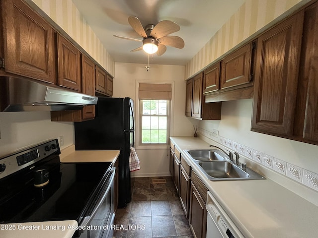7436 Creekside Dr Unit 10, Lansing, MI 48917 - kitchen with electric range, under cabinet range hood, a sink, and light countertops