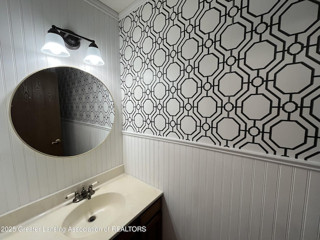 7436 Creekside Dr Unit 10, Lansing, MI 48917 - bathroom featuring wallpapered walls, ornamental molding, wainscoting, and vanity