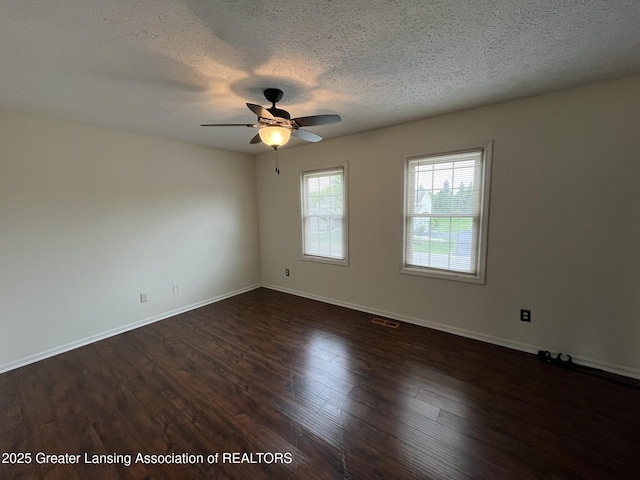 7436 Creekside Dr Unit 10, Lansing, MI 48917 - spare room featuring a ceiling fan, a textured ceiling, wood finished floors, and baseboards