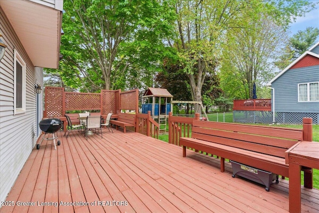 3720 Lott Ave, Holt, MI 48842 - deck with outdoor dining area and a playground