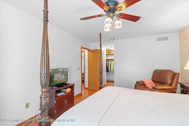 3720 Lott Ave, Holt, MI 48842 - bedroom featuring light wood-style flooring, a walk in closet, a ceiling fan, and a closet