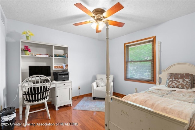 3720 Lott Ave, Holt, MI 48842 - bedroom featuring light wood-style floors, an office area, a textured ceiling, ceiling fan, and baseboards