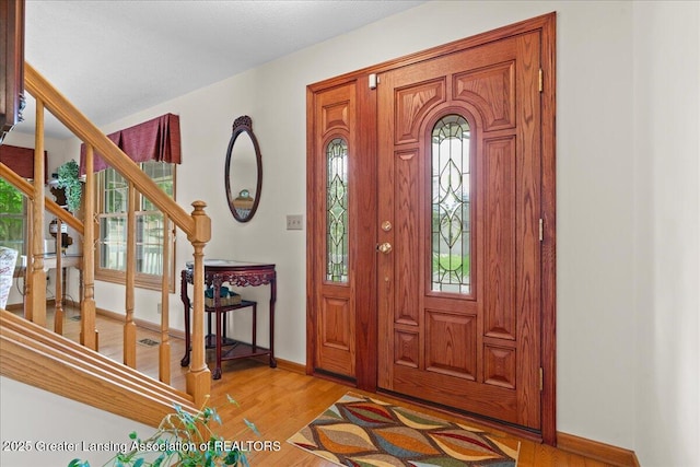 3720 Lott Ave, Holt, MI 48842 - entrance foyer featuring baseboards, stairway, and light wood-type flooring