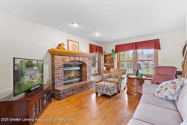 3720 Lott Ave, Holt, MI 48842 - living area with a fireplace, wood finished floors, and recessed lighting