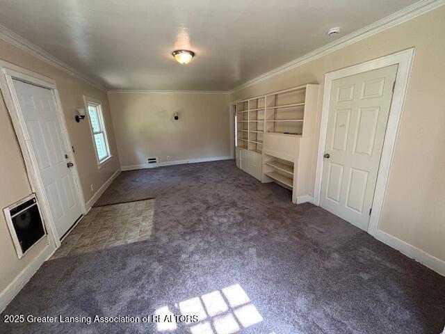 704 Mckim Ave, Lansing, MI 48910 - unfurnished living room featuring carpet, crown molding, and built in features