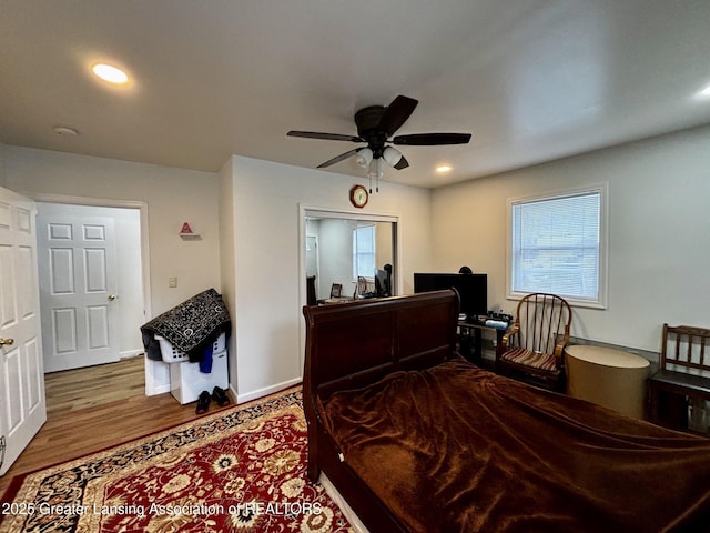 1916 W Jolly Rd, Lansing, MI 48910 - bedroom with multiple windows, wood finished floors, recessed lighting, ceiling fan, and baseboards