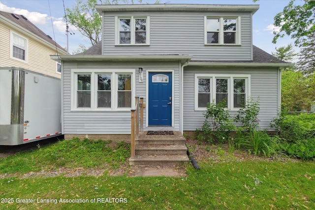 5104 Old Lansing Rd, Lansing, MI 48917 - view of front of house with roof with shingles and a front yard