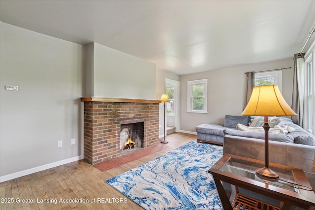 5104 Old Lansing Rd, Lansing, MI 48917 - living room with wood-type flooring, baseboards, and a brick fireplace